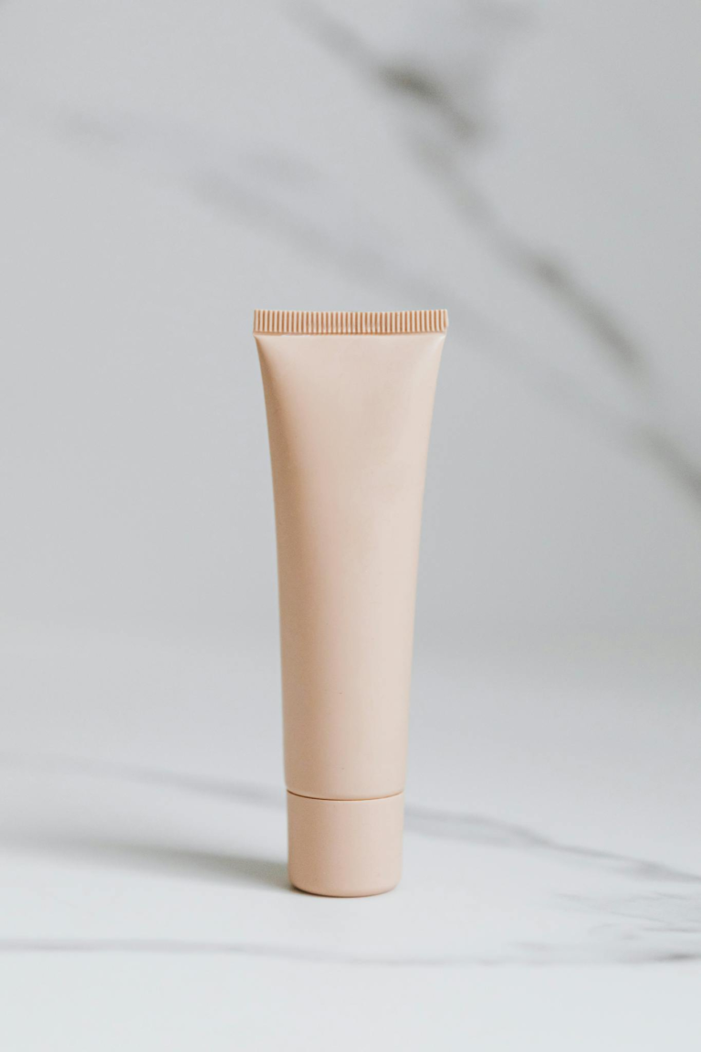 Elegant skincare tube on marble with a clean, minimalist design.