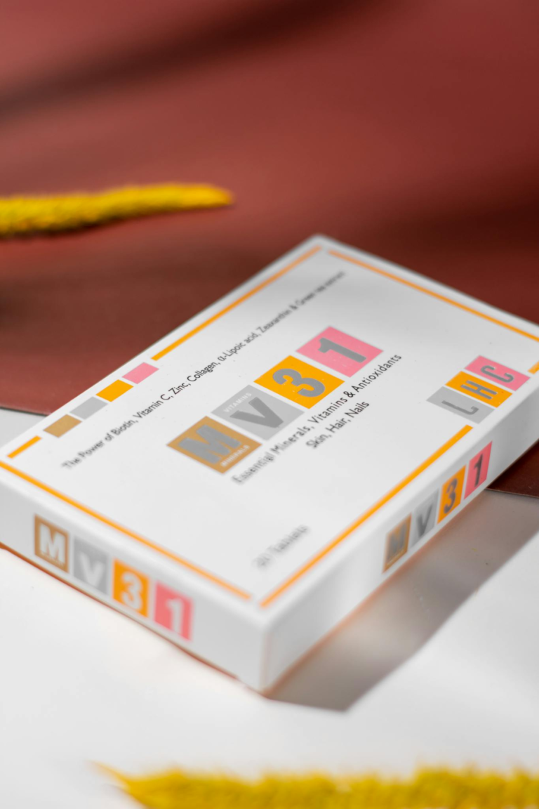 Sleek cosmetics packaging in a modern, minimalist design on a textured background.